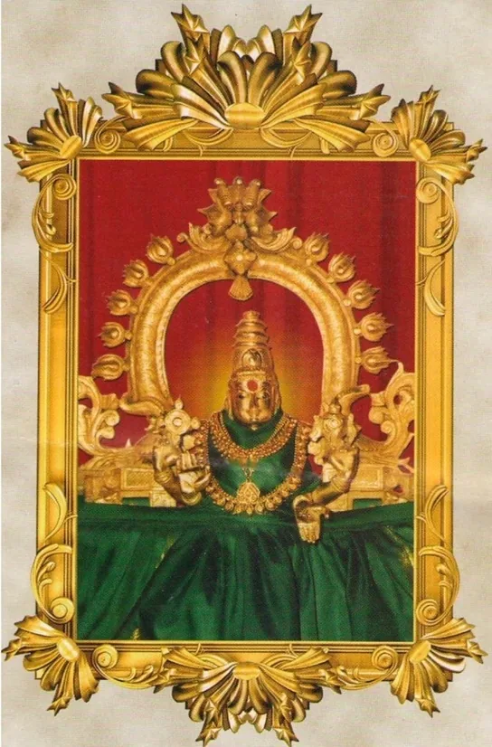 Sree Bhagavathy in green silk, in an ornate golden frame